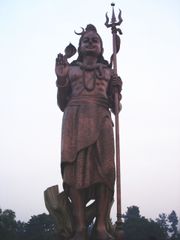 A massive sculpture of Lord Shiva holding a trident (Trishula).
